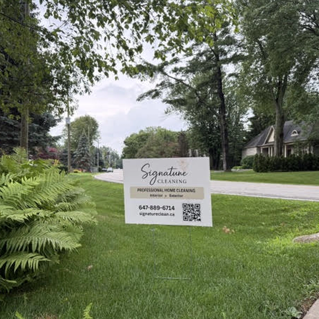 Signature Cleaning lawn sign by a freshly cleaned driveway